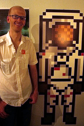 Me standing next to large pixel astronaut.